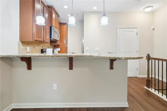 a view of a kitchen with a sink and mirror