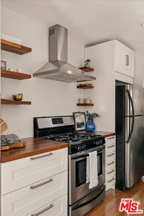 3764 Valleybrink Road Los Angeles, CA 90039 - Photo 12 of 35 a kitchen with stainless steel appliances a stove and a refrigerator