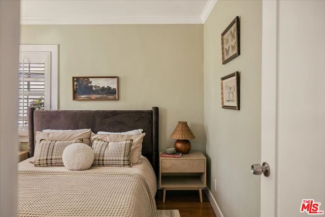 a bedroom with a bed and wall painting