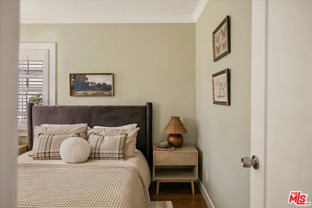 a bedroom with a bed and wall painting