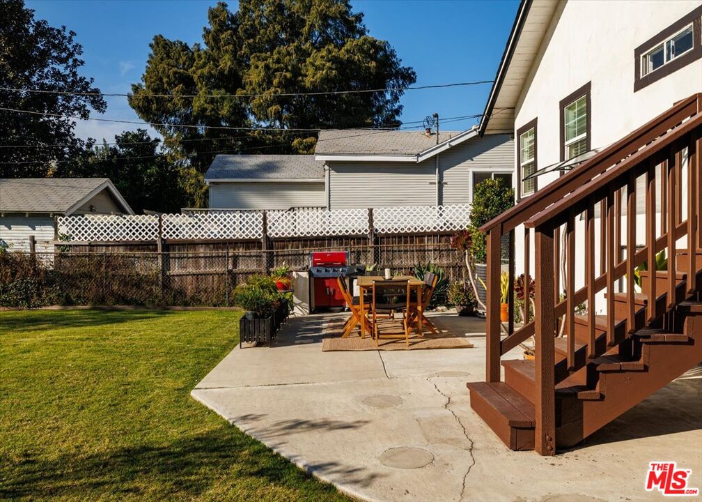 3764 Valleybrink Road Los Angeles, CA 90039 - Photo 25 of 35 a view of a patio with table and chairs with wooden floor and fence