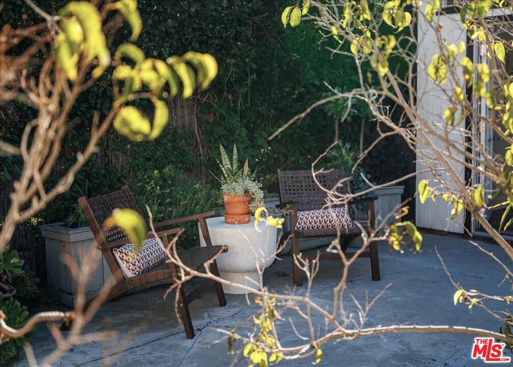 3764 Valleybrink Road Los Angeles, CA 90039 - Photo 31 of 35 a backyard of a house with table and chairs
