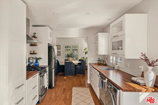 a kitchen with stainless steel appliances a sink stove and refrigerator