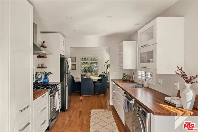 a kitchen with stainless steel appliances a sink stove and refrigerator