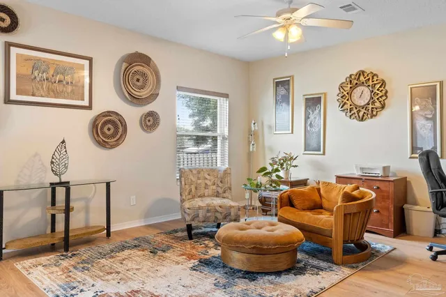 a living room with furniture and a clock