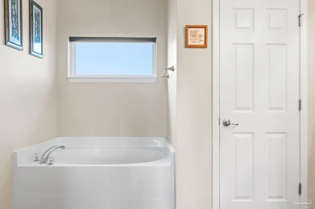 a white bath tub sitting next to a window