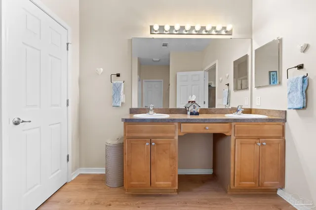 a bathroom with a double vanity sink and a mirror