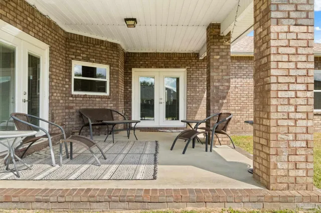 a view of a patio with table and chairs