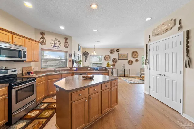a kitchen with a sink stove and cabinets
