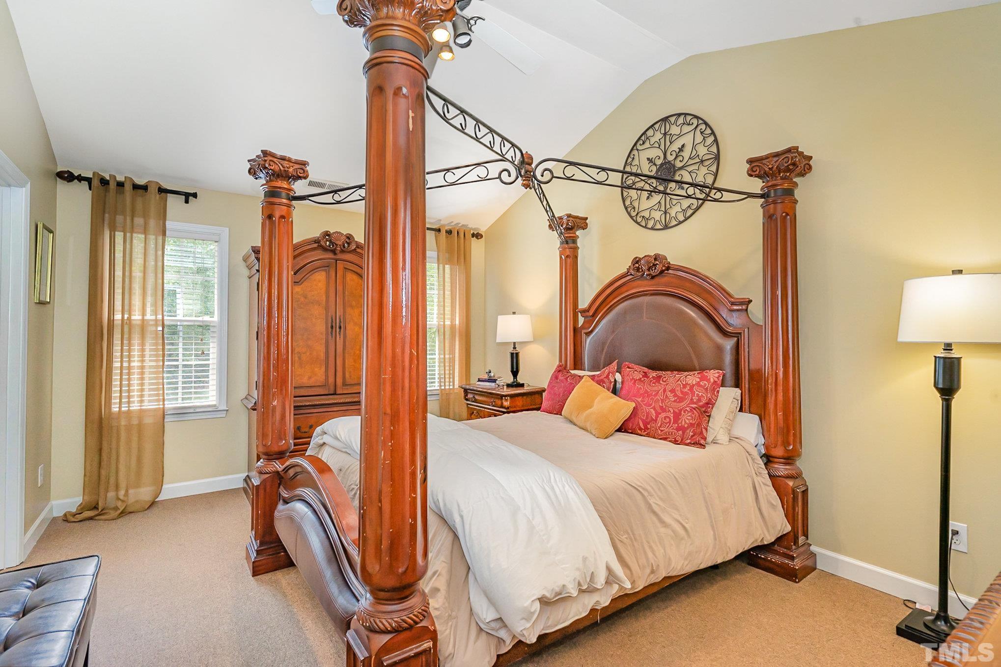 6026 Kohler Lane Raleigh, NC 27616 - Photo 11 of 15 a bedroom with a bed and a chandelier