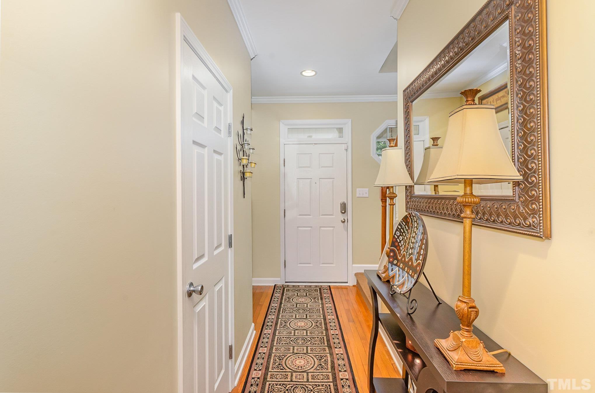 6026 Kohler Lane Raleigh, NC 27616 - Photo 5 of 15 a view of a hallway with wooden floor and a bathroom