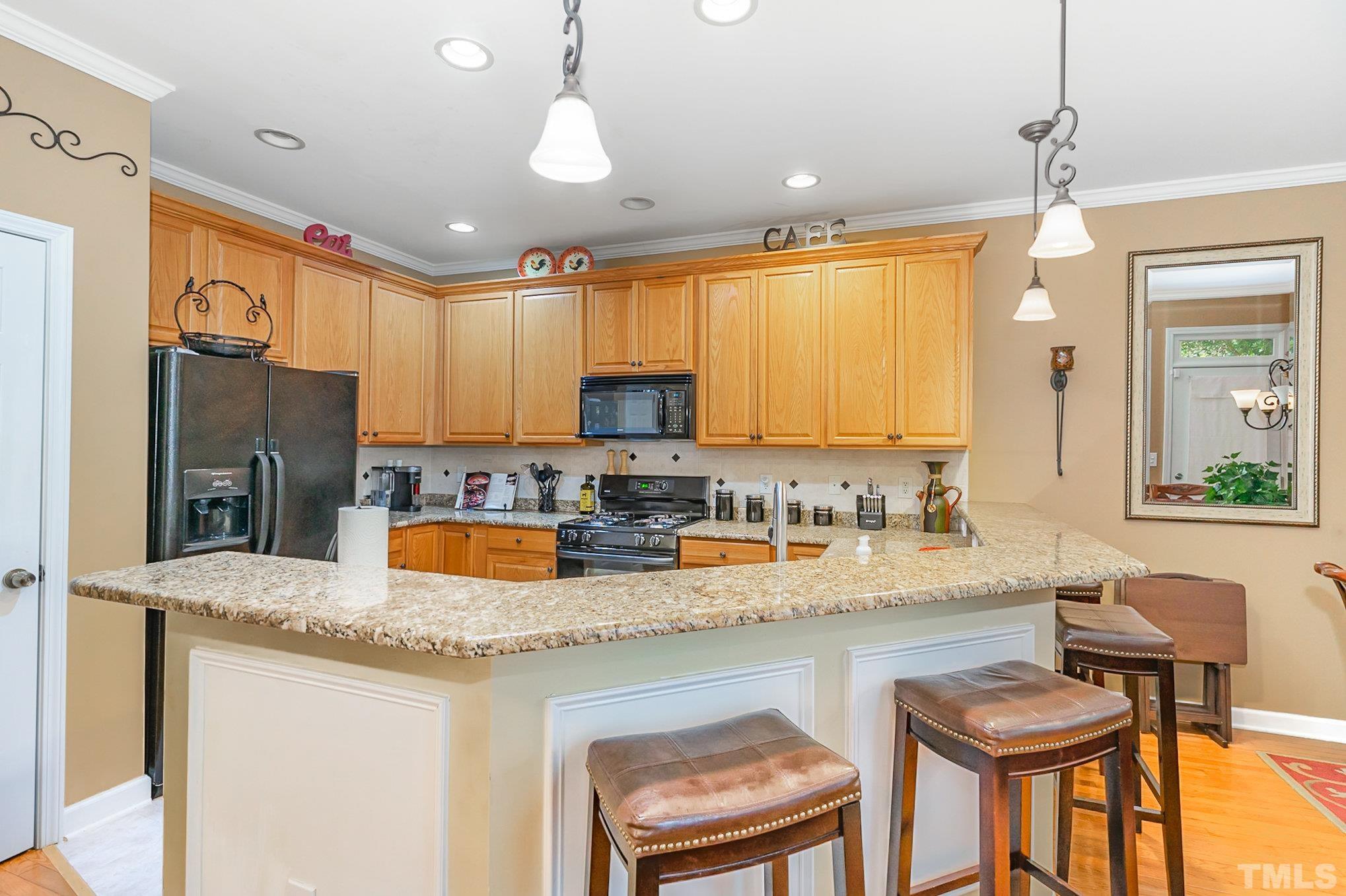 6026 Kohler Lane Raleigh, NC 27616 - Photo 8 of 15 a kitchen with stainless steel appliances granite countertop a sink a stove a refrigerator a center island and furniture