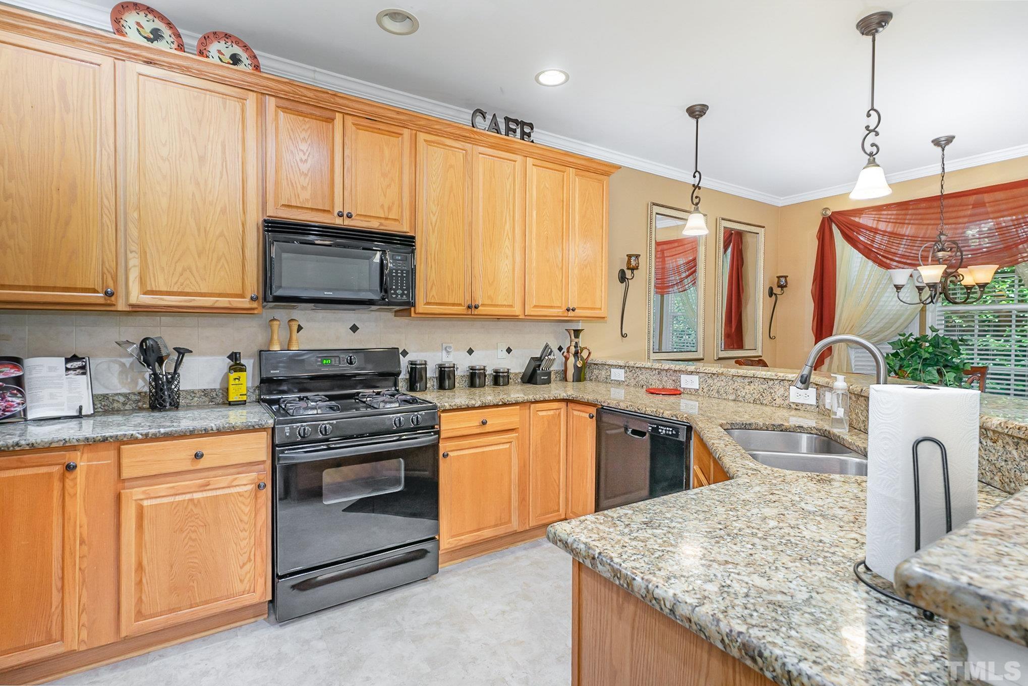 6026 Kohler Lane Raleigh, NC 27616 - Photo 9 of 15 a kitchen with stainless steel appliances granite countertop a stove a sink and a microwave