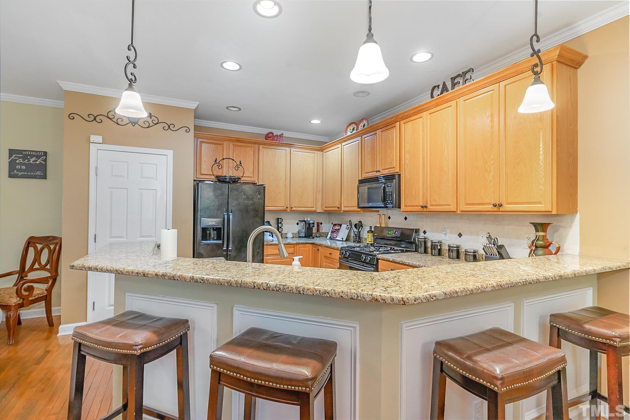 6026 Kohler Lane Raleigh, NC 27616 - Photo 10 of 15 a kitchen with granite countertop a sink a center island and cabinets