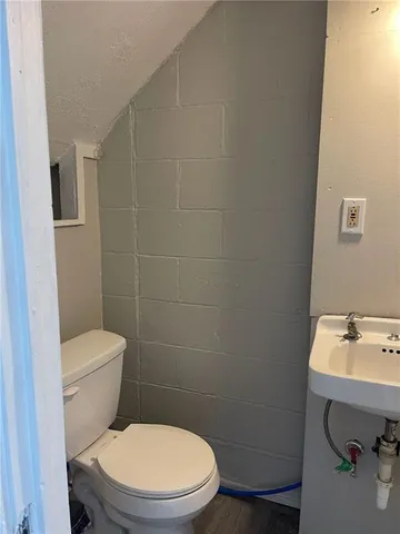 a white toilet sitting next to a bathroom sink