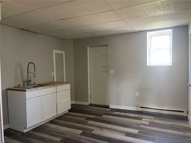 a room with a sink and cabinets