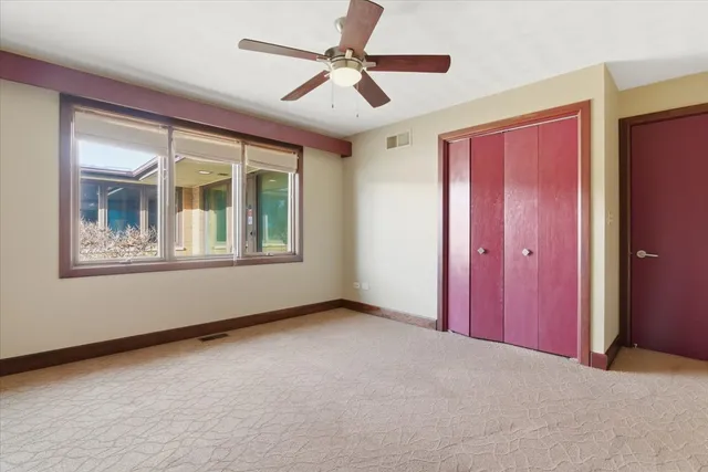 a view of a livingroom with a ceiling fan and window