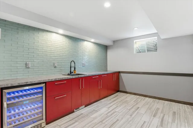 a bathroom with a granite countertop toilet sink and mirror