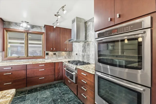 a kitchen with a sink appliances and cabinets