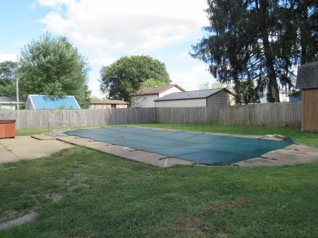 a view of backyard with a garden and trees