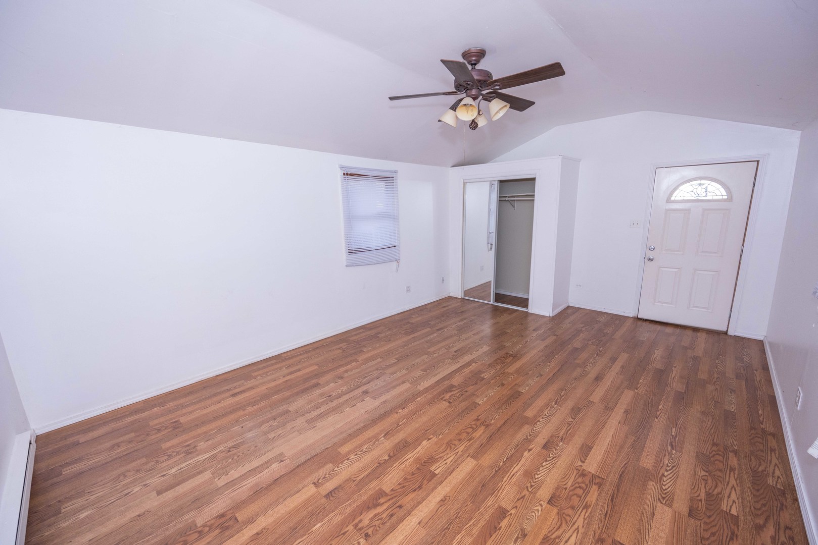 2024 Plainfield Road Crest Hill, IL 60403 - Photo 12 of 20 a view of a room with wooden floor and a ceiling fan