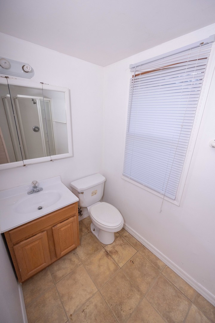 2024 Plainfield Road Crest Hill, IL 60403 - Photo 15 of 20 a bathroom with a sink a toilet and shower