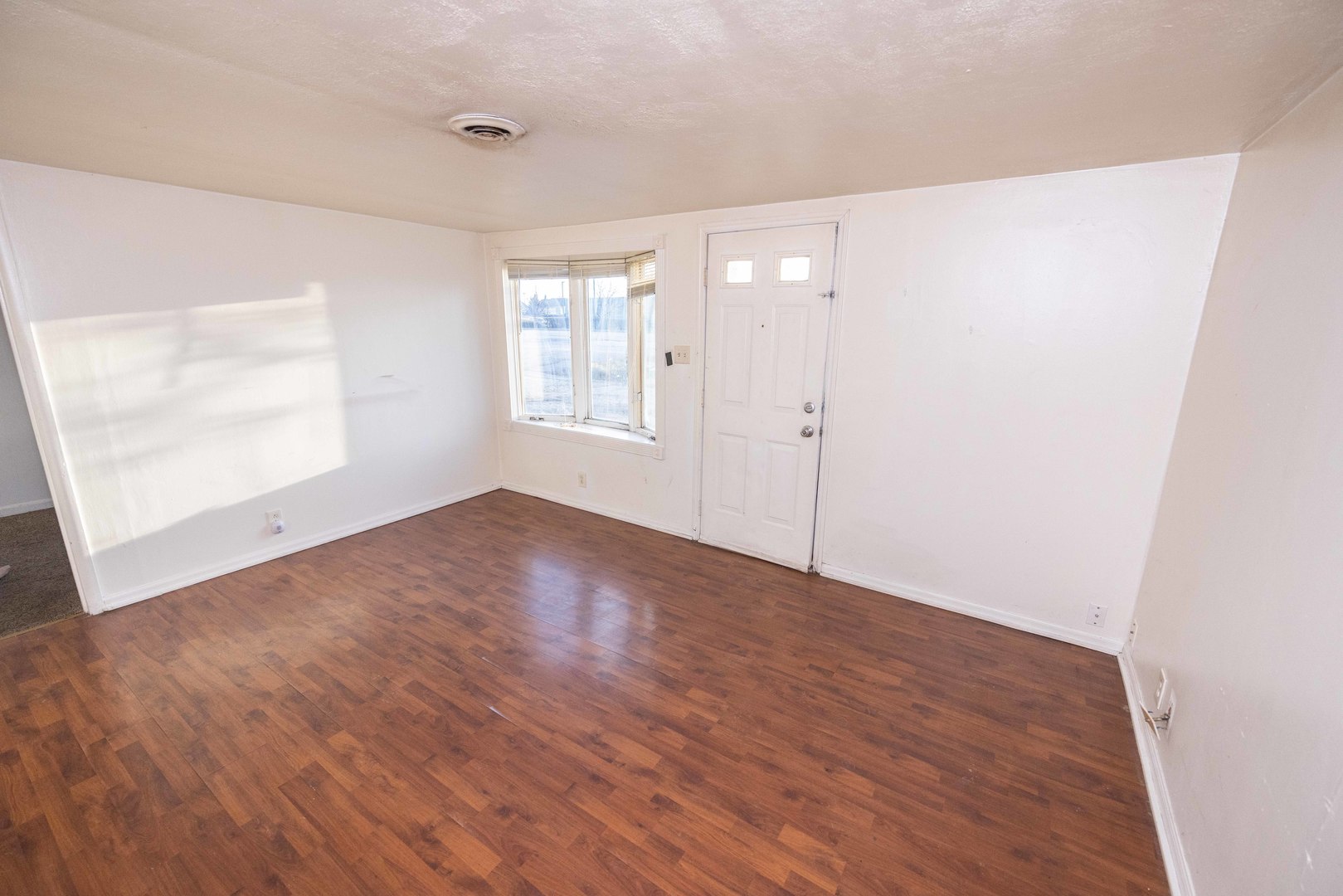 2024 Plainfield Road Crest Hill, IL 60403 - Photo 2 of 20 an empty room with wooden floor and windows