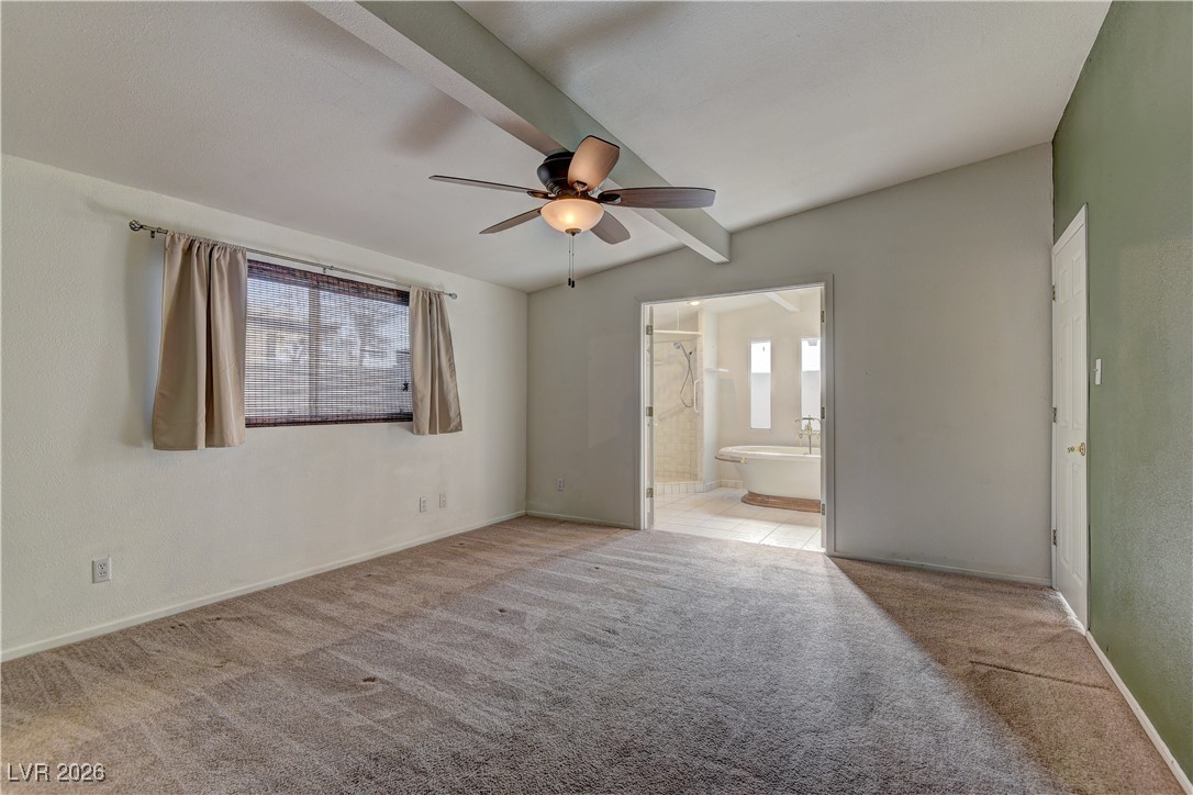 6309 Rassler Avenue Las Vegas, NV 89107 - Photo 10 of 19 Unfurnished bedroom featuring connected bathroom, light carpet, and ceiling fan