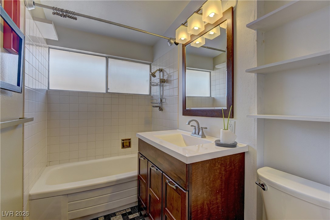 6309 Rassler Avenue Las Vegas, NV 89107 - Photo 14 of 19 Full bathroom featuring shower / bath combination and vanity