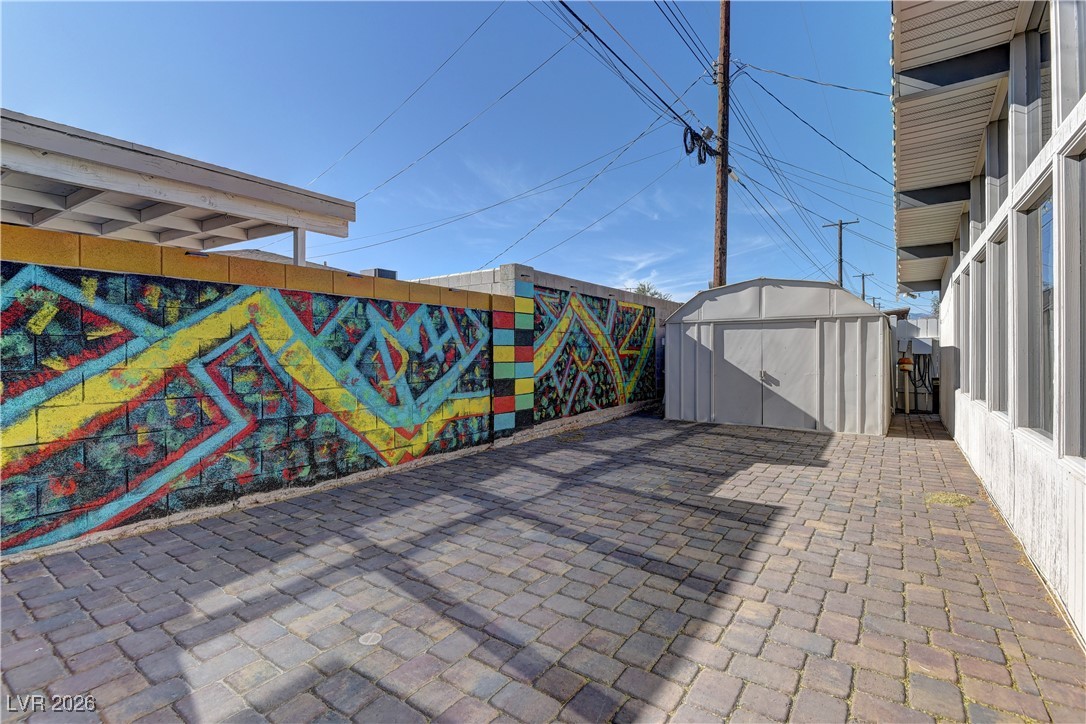 6309 Rassler Avenue Las Vegas, NV 89107 - Photo 17 of 19 Fenced backyard featuring a shed and a patio area
