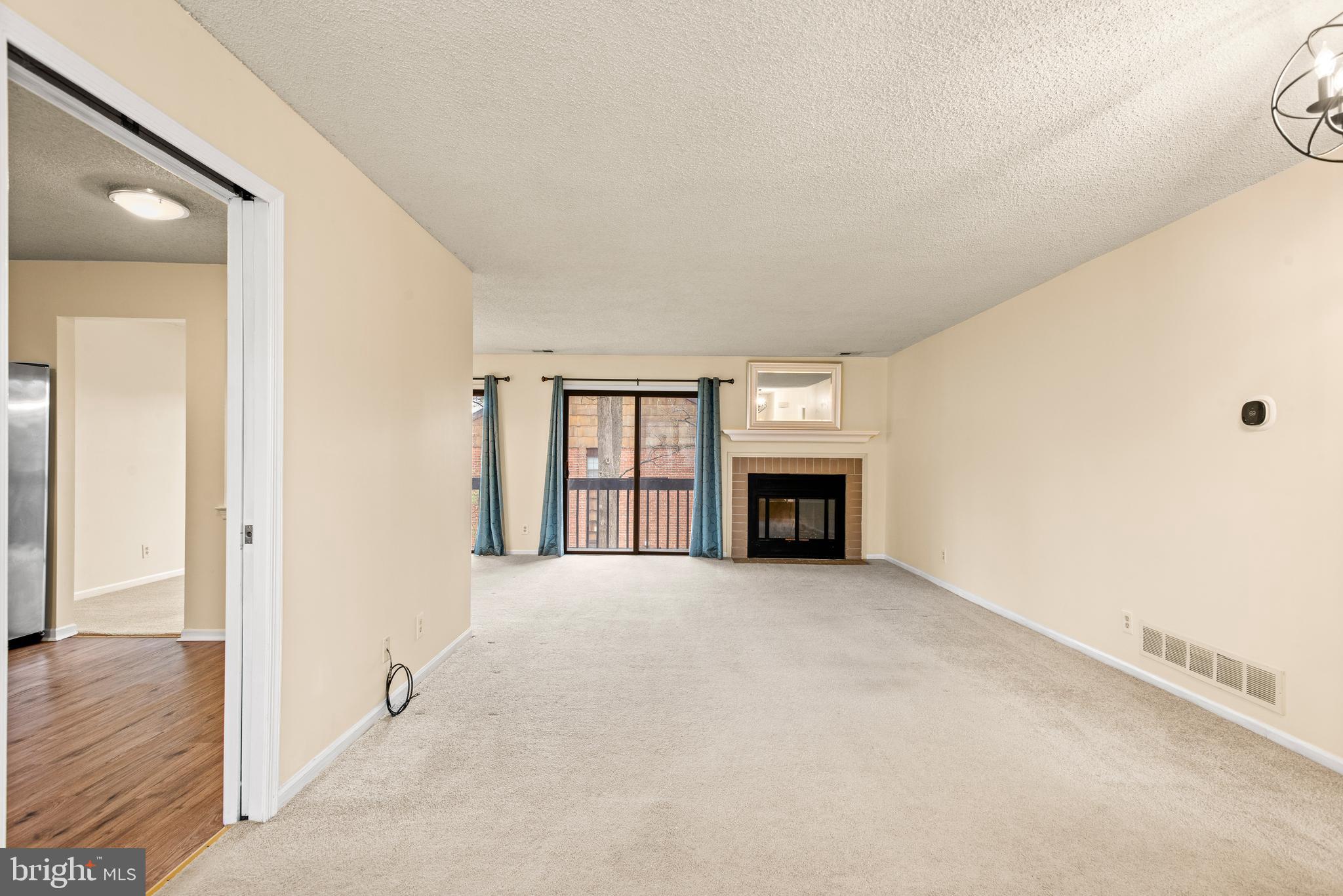 1108 Bartlett Road, Unit 170 Chesterbrook, PA 19087 - Photo 12 of 22 a view of an empty room with wooden floor and a window