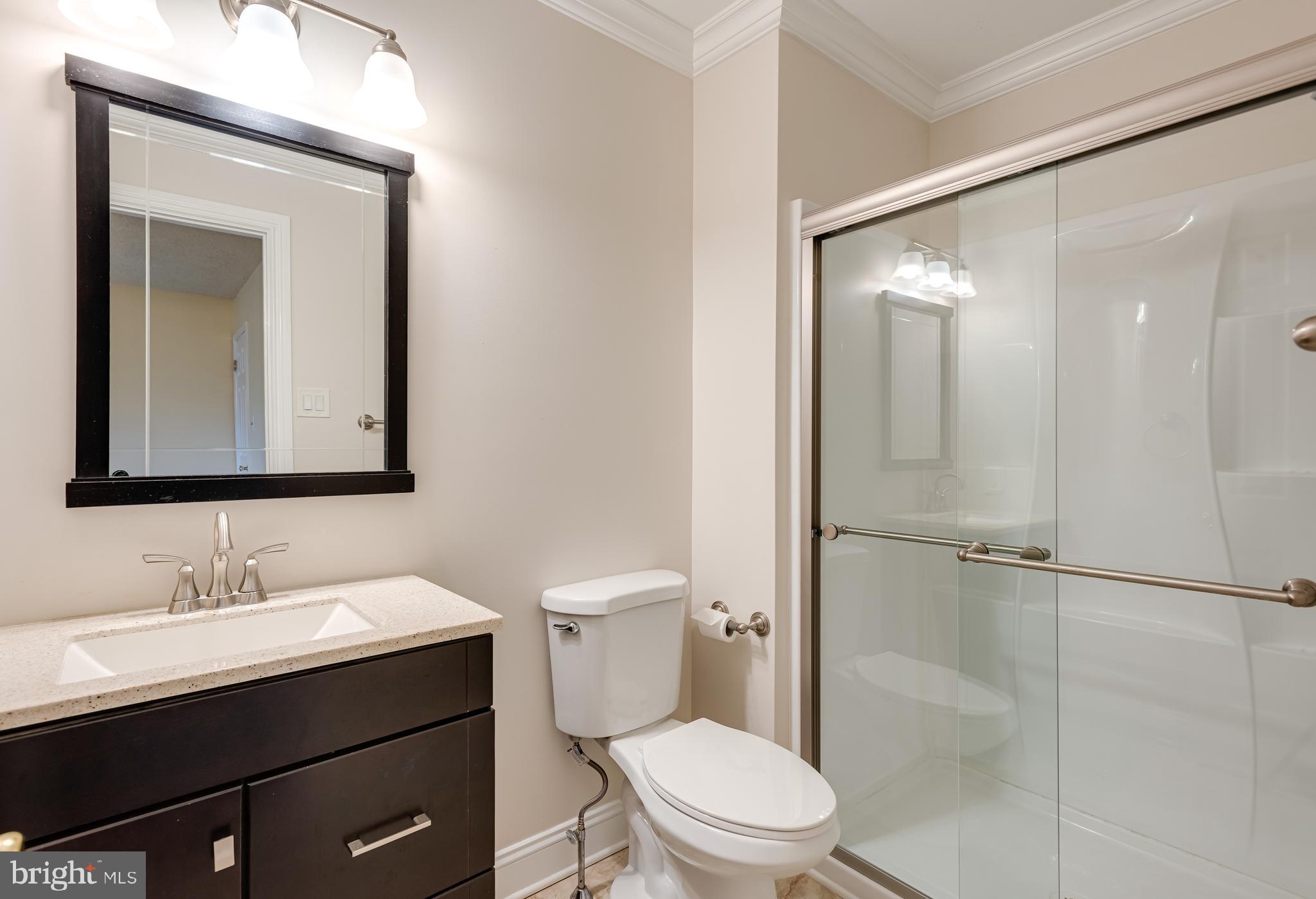 1108 Bartlett Road, Unit 170 Chesterbrook, PA 19087 - Photo 14 of 22 a bathroom with a toilet a sink a mirror and vanity