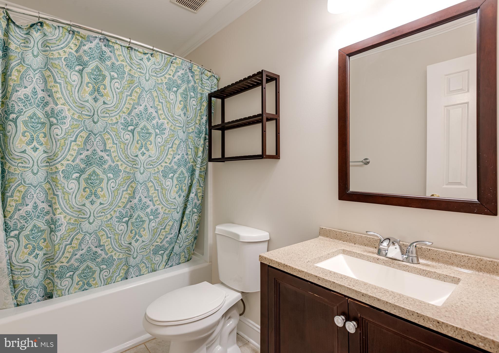 1108 Bartlett Road, Unit 170 Chesterbrook, PA 19087 - Photo 18 of 22 a bathroom with a granite countertop sink a toilet and a mirror
