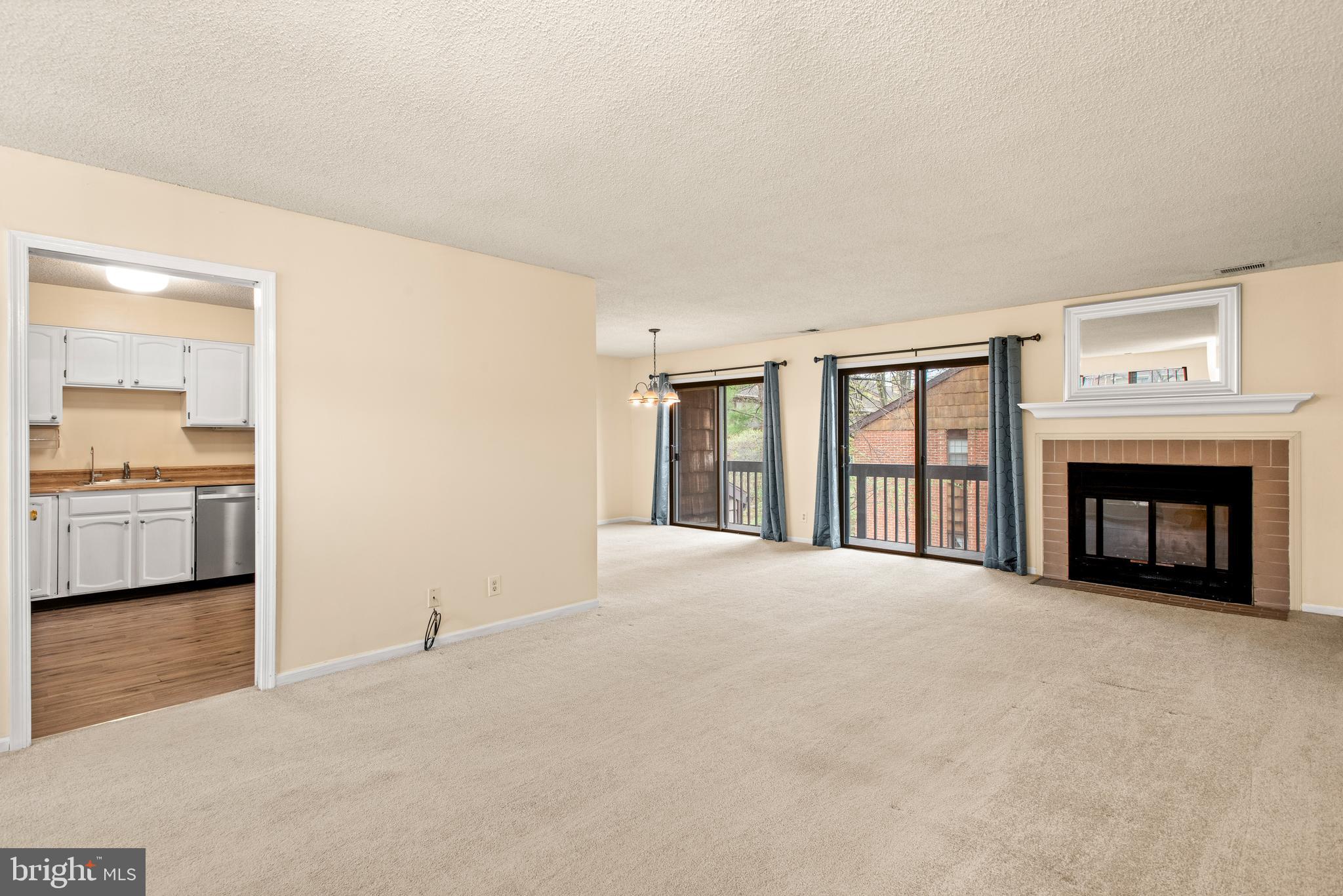 1108 Bartlett Road, Unit 170 Chesterbrook, PA 19087 - Photo 2 of 22 a view of an empty room with a fireplace and a window