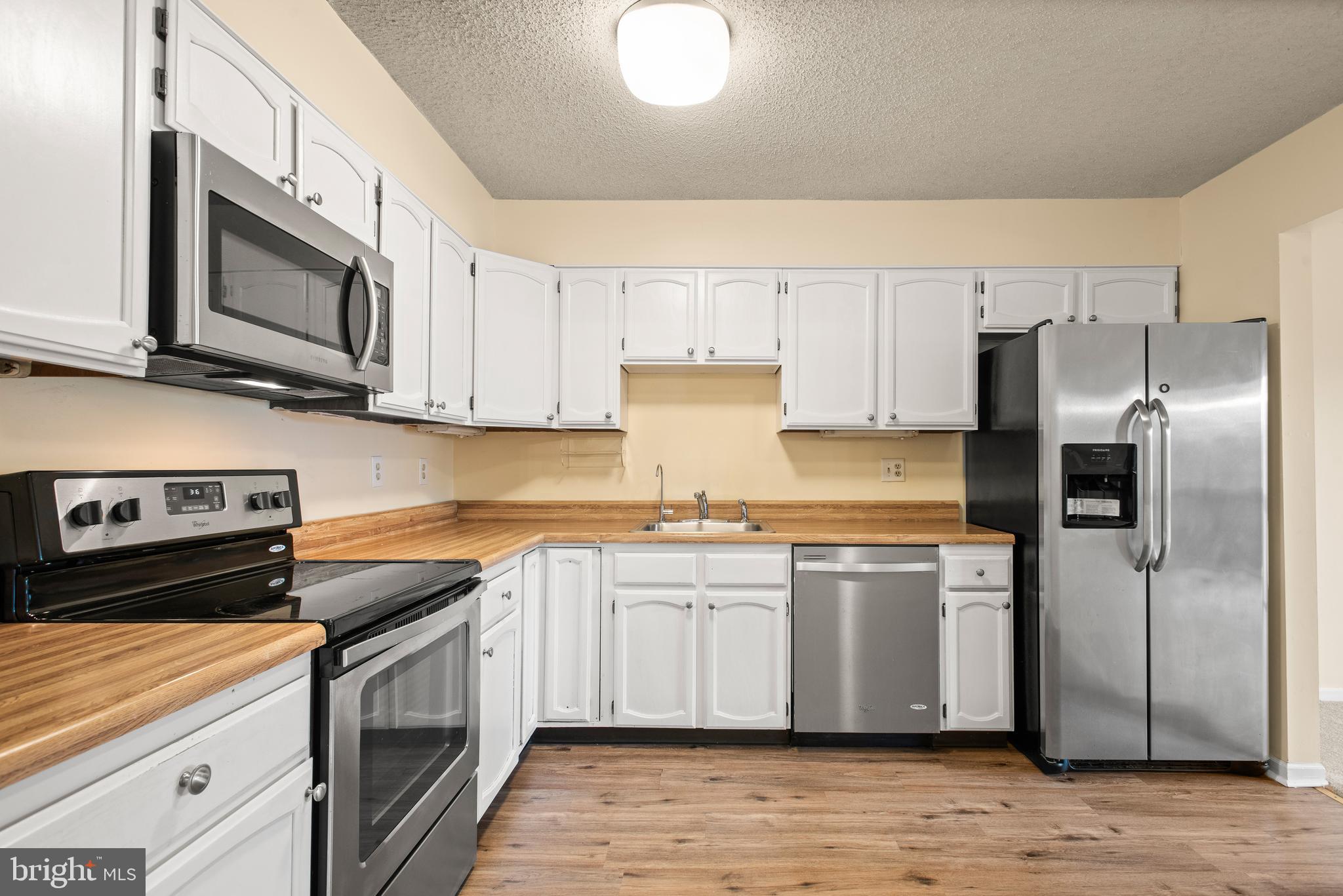 1108 Bartlett Road, Unit 170 Chesterbrook, PA 19087 - Photo 10 of 22 a kitchen with stainless steel appliances granite countertop a stove a sink and a microwave