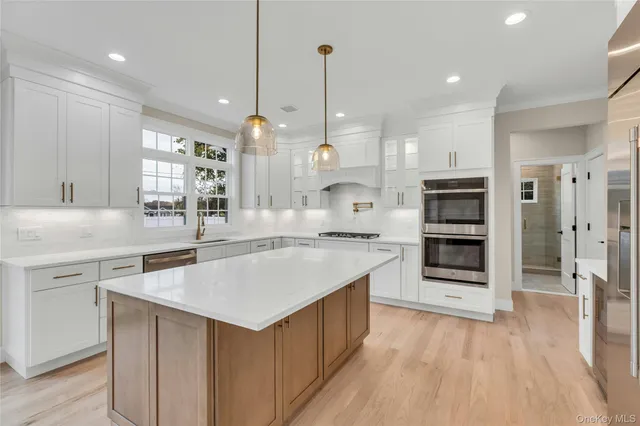 a view of a kitchen with a sink and a refrigerator
