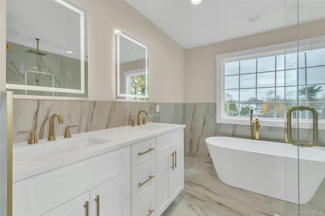 a bathroom with a shower a mirror and a sink