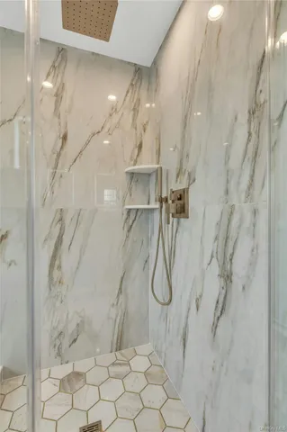a bathroom with a sink vanity granite toilet and shower