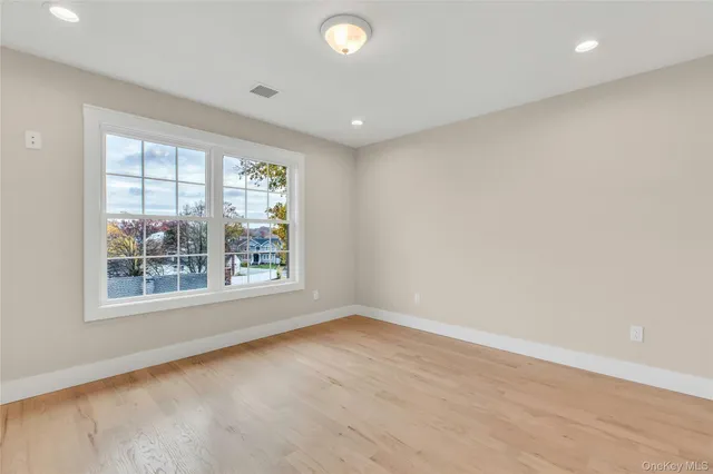 a bathroom with a double vanity sink a mirror and next to a window