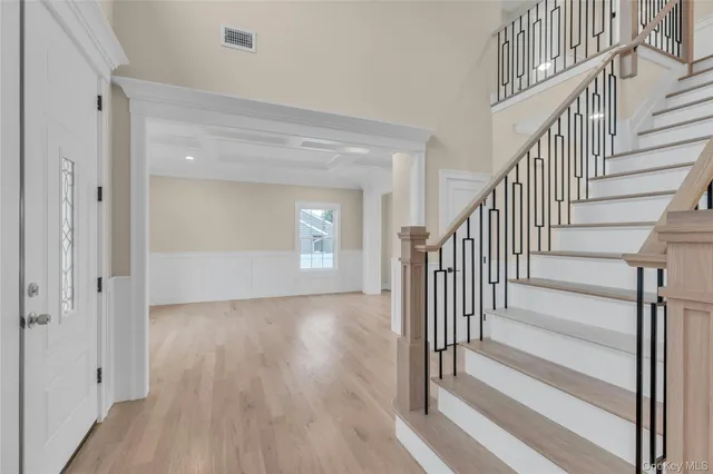 a view of a hallway with wooden floor and entryway