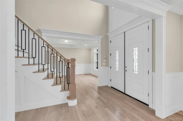 a view of entryway and hall with wooden floor