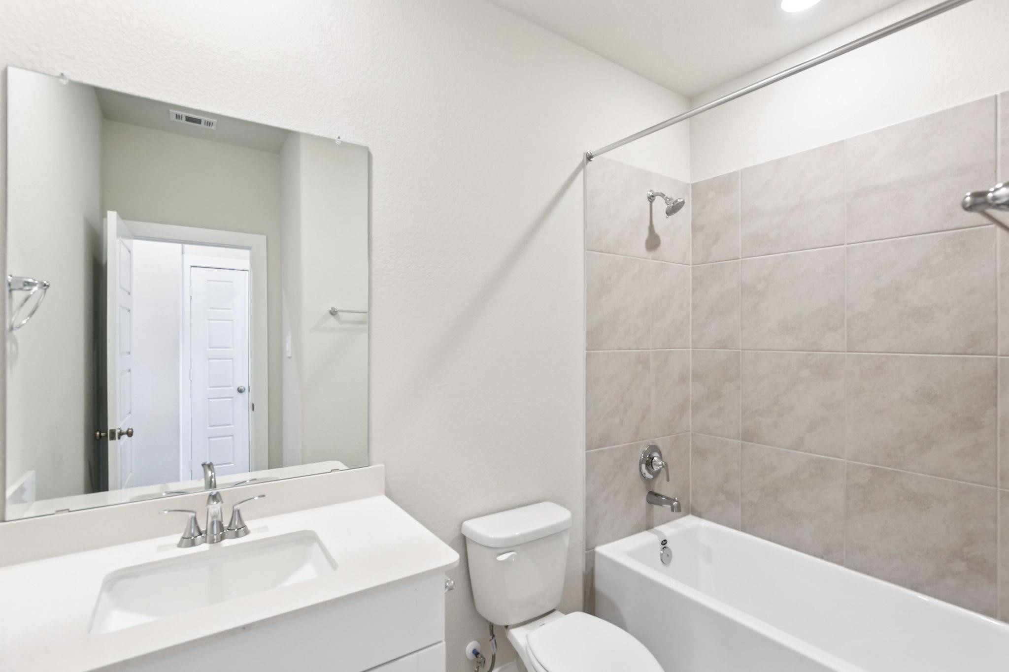 6717 Chinapkin Lane Conroe, TX 77304 - Photo 11 of 15 a bathroom with a sink toilet and shower