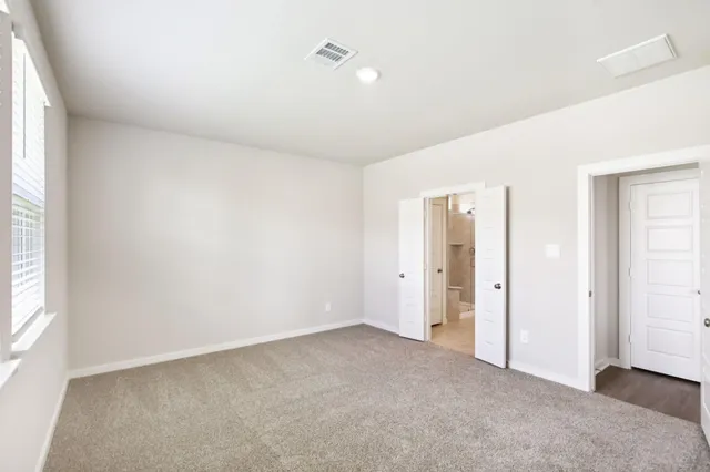 an empty room with windows and closet