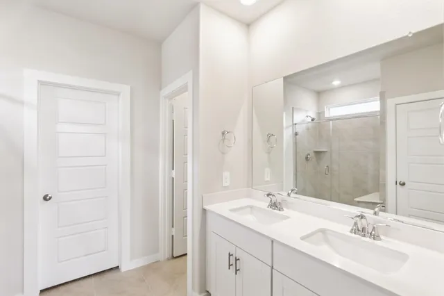 a bathroom with 2 sink and a mirror