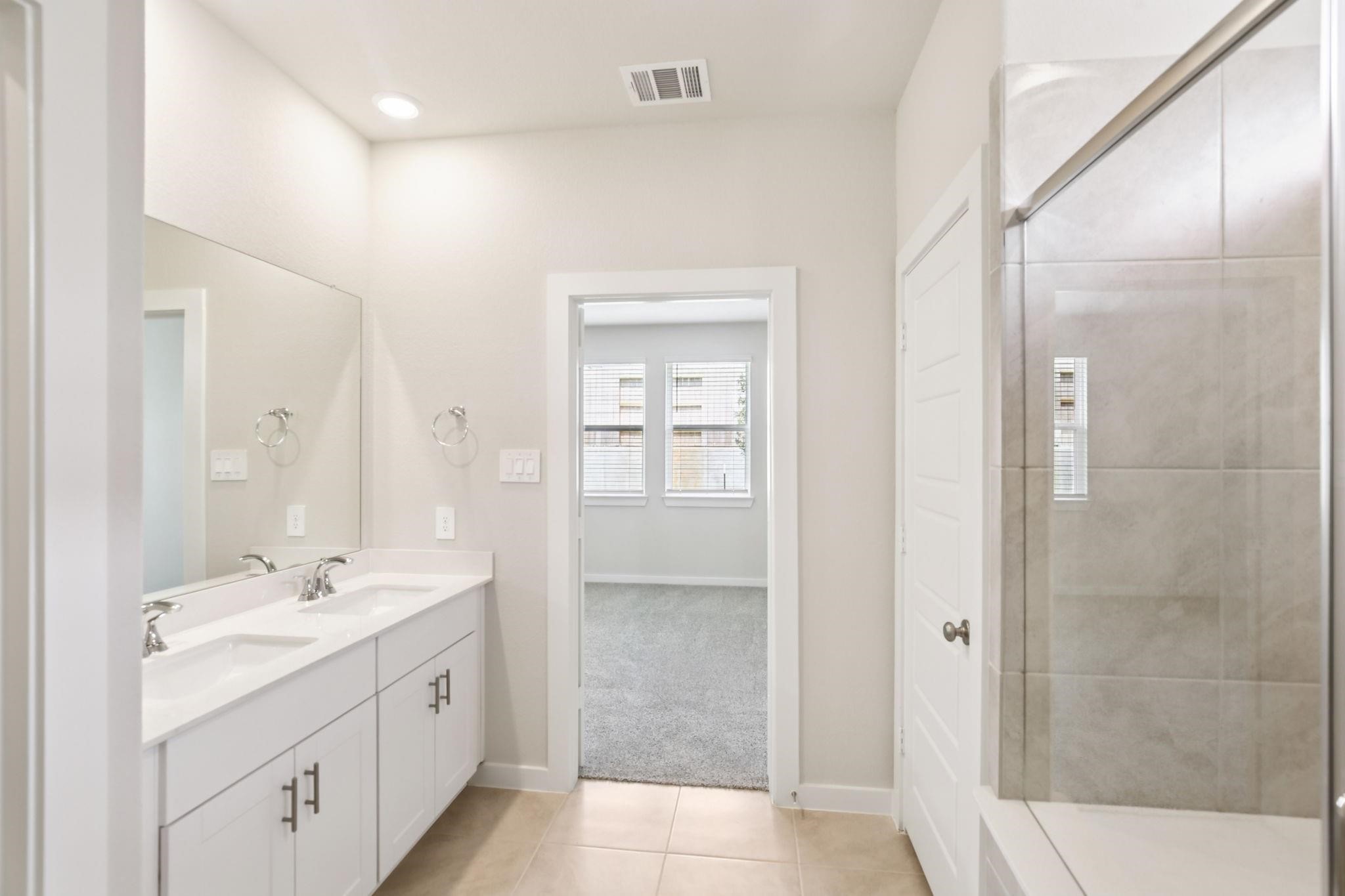 6717 Chinapkin Lane Conroe, TX 77304 - Photo 9 of 15 a spacious bathroom with a shower sink and mirror