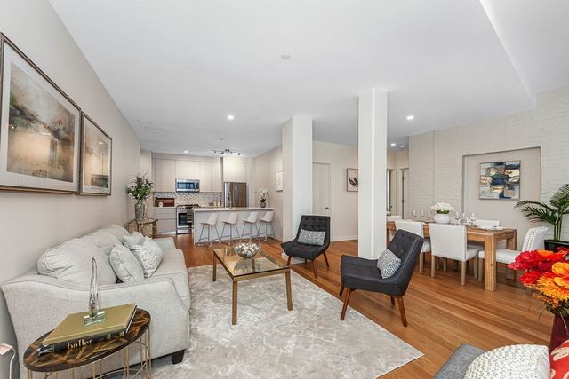 a living room with furniture and kitchen view