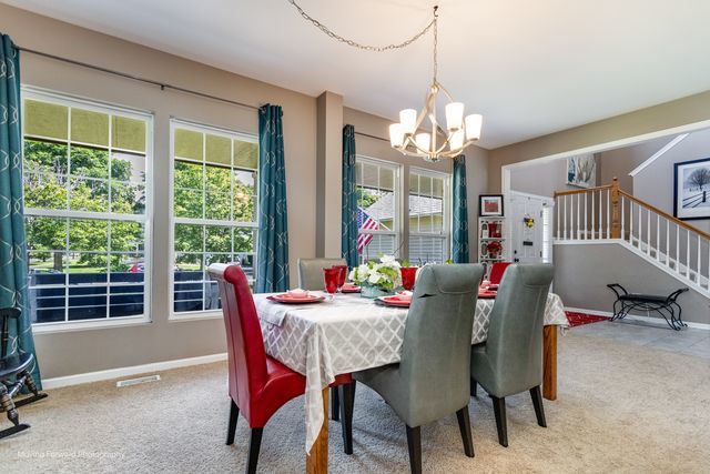 103 South Cranberry Street Bolingbrook, IL 60490 - Photo 12 of 33 a dining room with furniture a chandelier and window