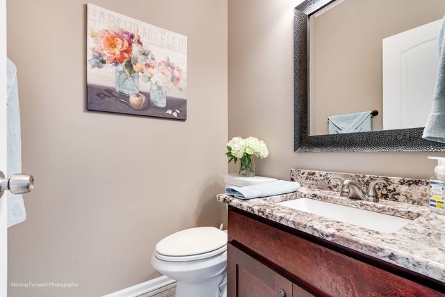 103 South Cranberry Street Bolingbrook, IL 60490 - Photo 14 of 33 a bathroom with a granite countertop sink and a mirror with toilet