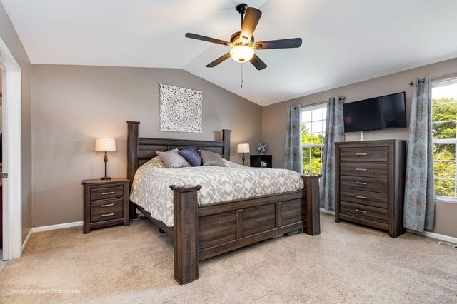 103 South Cranberry Street Bolingbrook, IL 60490 - Photo 16 of 33 a bedroom with a bed and a flat tv screen on dresser