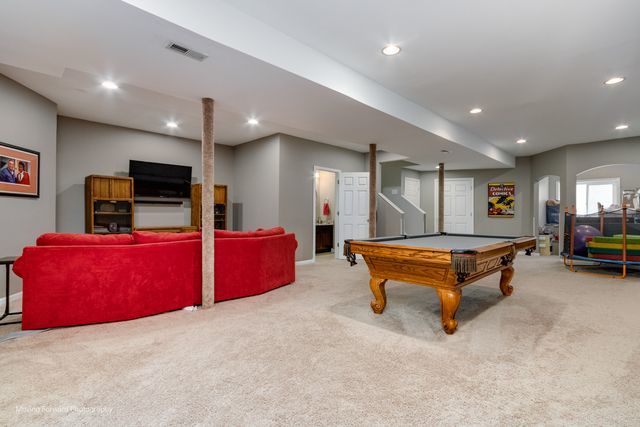 103 South Cranberry Street Bolingbrook, IL 60490 - Photo 23 of 33 a living room with furniture and a flat screen tv